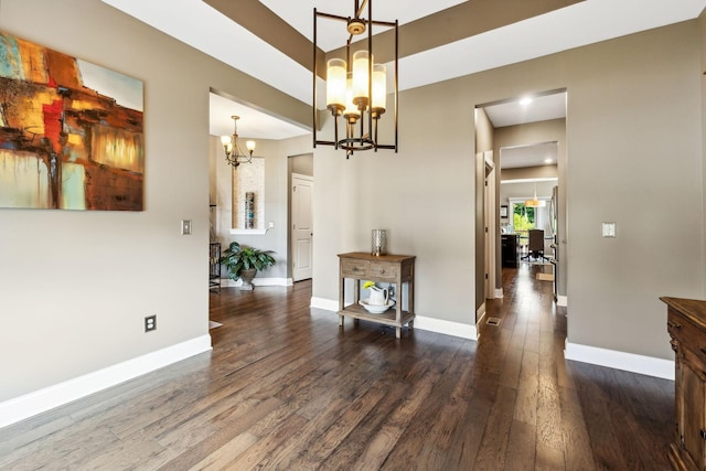 dining space with dark wood-type flooring and an inviting chandelier