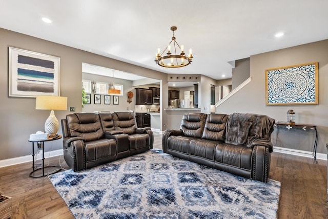 living area featuring dark wood-style flooring, recessed lighting, an inviting chandelier, and baseboards