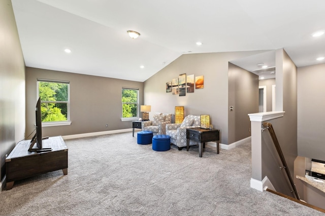 living area featuring lofted ceiling and light colored carpet