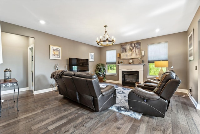 living room with baseboards, a chandelier, and wood finished floors