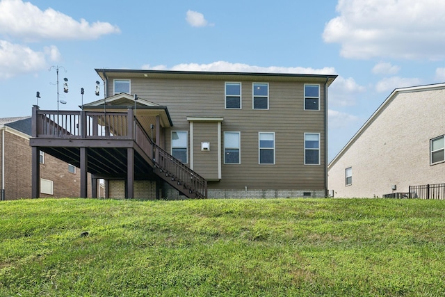 rear view of house with stairs, a lawn, and a wooden deck