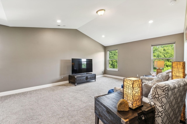 carpeted living room with lofted ceiling