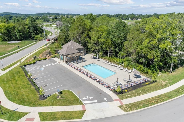 drone / aerial view featuring a wooded view