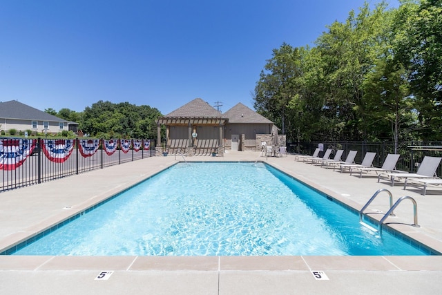 pool with a gazebo, a patio area, and fence