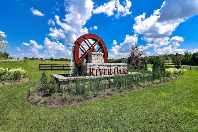 exterior space featuring fence, a lawn, and a rural view