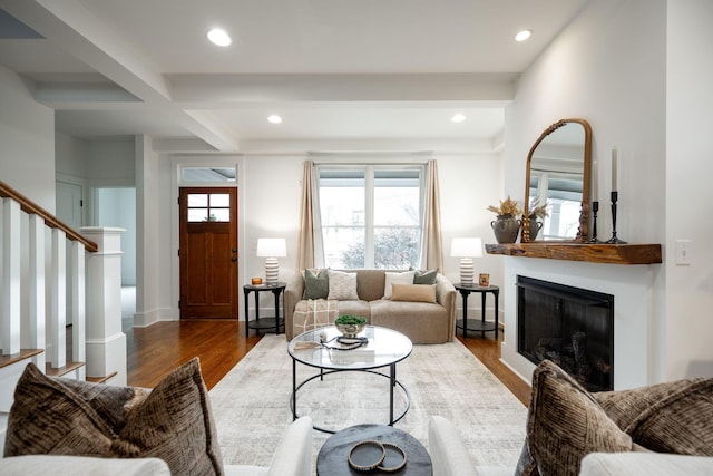 living room featuring hardwood / wood-style flooring and beamed ceiling