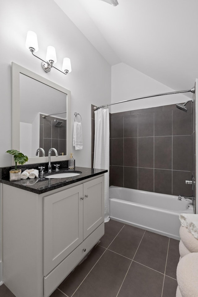 bathroom with tile patterned floors, vaulted ceiling, vanity, and shower / bath combo