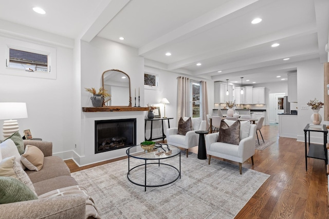 living room with hardwood / wood-style flooring and beam ceiling