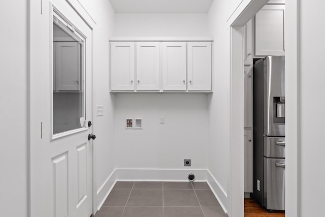 clothes washing area featuring cabinets, washer hookup, hookup for an electric dryer, and dark tile patterned floors