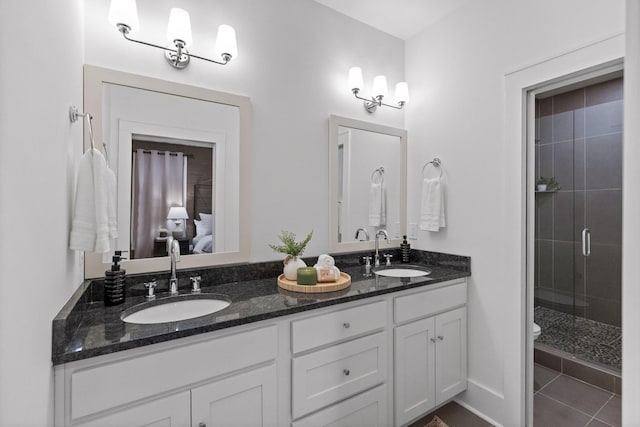 bathroom featuring vanity, an enclosed shower, tile patterned flooring, and toilet