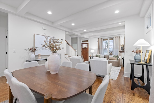 dining area featuring wood-type flooring and beam ceiling