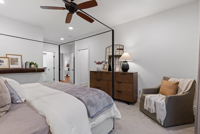 bedroom with ceiling fan and light colored carpet