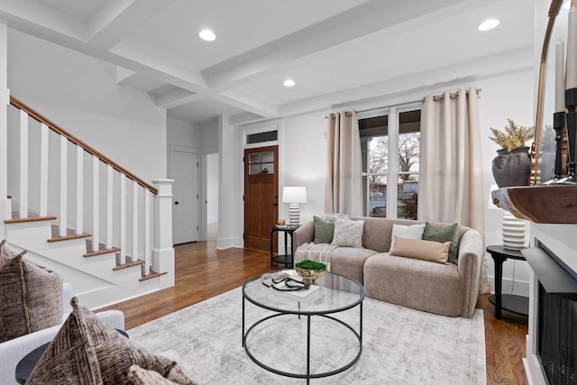 living room featuring coffered ceiling, beam ceiling, and wood-type flooring