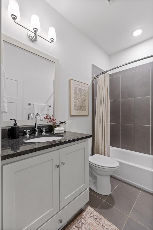 full bathroom with tile patterned flooring, vanity, shower / bath combo with shower curtain, and toilet