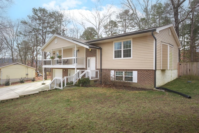 split foyer home with a garage and a front lawn