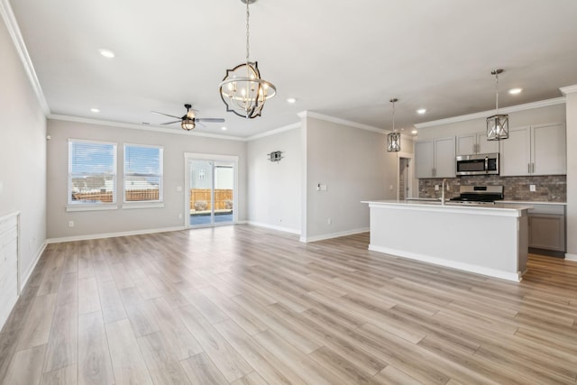 kitchen featuring appliances with stainless steel finishes, pendant lighting, and gray cabinetry