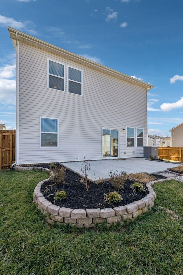 rear view of property featuring a patio and a lawn