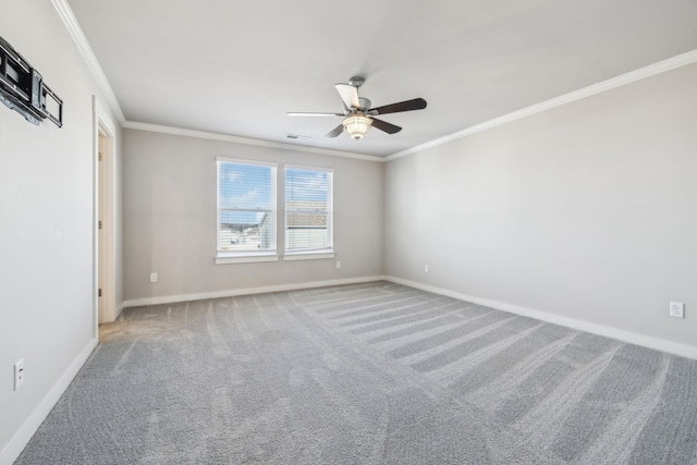 spare room with ornamental molding, carpet, and ceiling fan