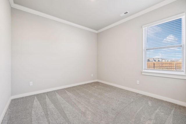 empty room with ornamental molding and carpet