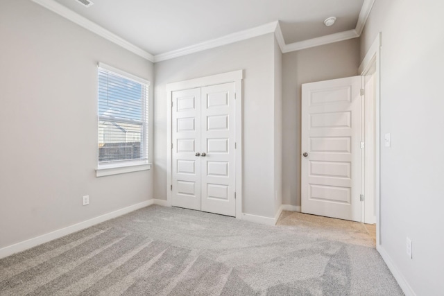 unfurnished bedroom with light colored carpet, ornamental molding, and a closet