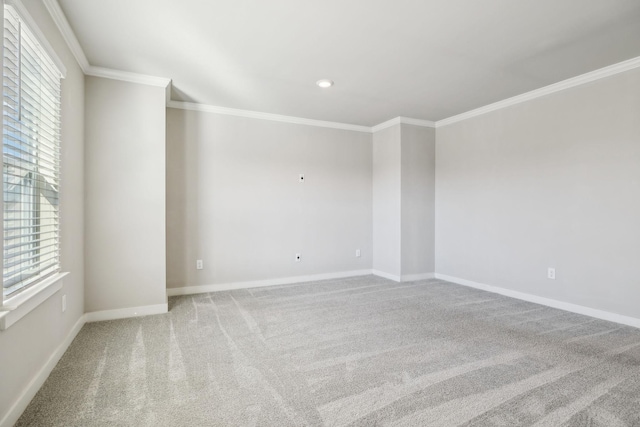 carpeted spare room featuring ornamental molding