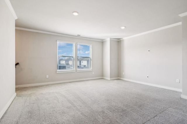 carpeted spare room featuring crown molding