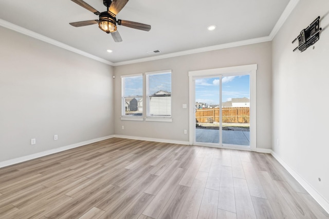 spare room with crown molding and light hardwood / wood-style floors