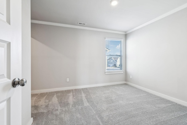 spare room featuring ornamental molding and carpet flooring