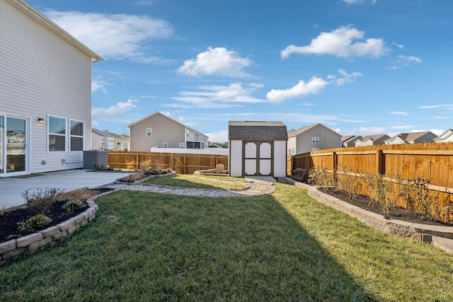 view of yard with a patio area and a storage unit