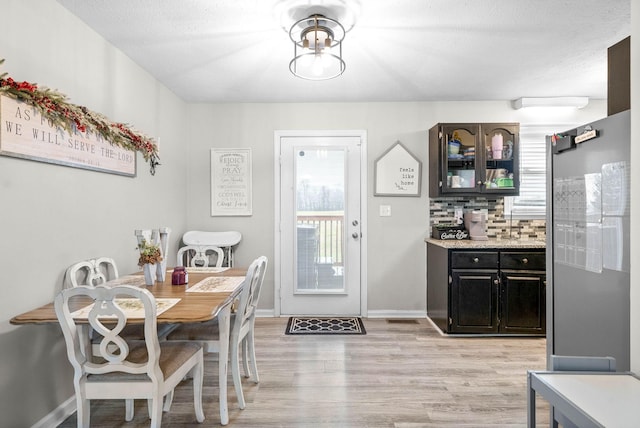 dining room with a wealth of natural light and light hardwood / wood-style floors