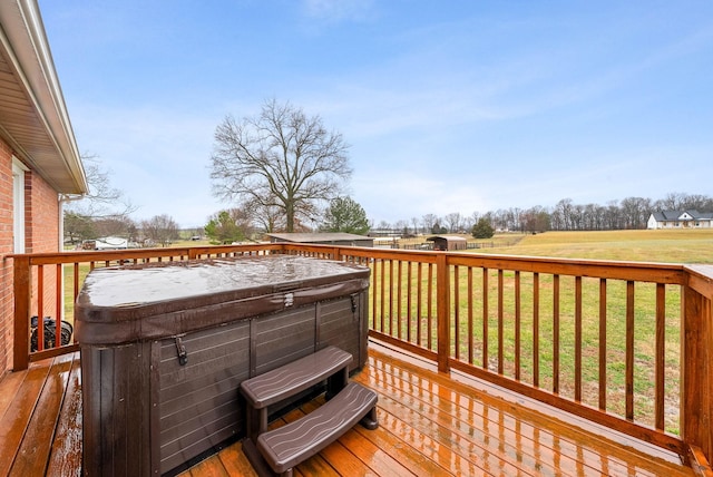 wooden terrace featuring a lawn and a hot tub