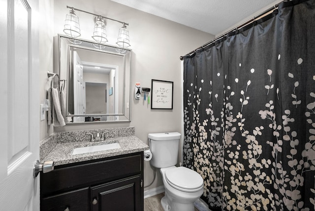 bathroom featuring vanity, a textured ceiling, toilet, and a shower with shower curtain