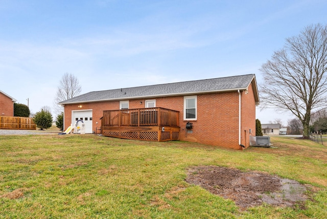 back of house with a garage, a yard, central AC, and a wooden deck