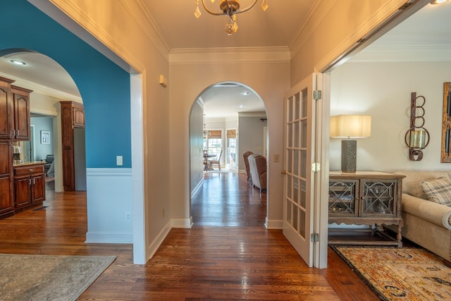 corridor with ornamental molding and dark hardwood / wood-style floors