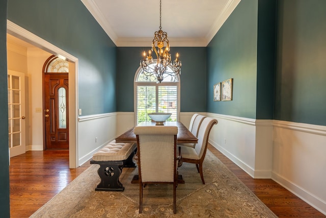 dining room with dark hardwood / wood-style flooring, a notable chandelier, and crown molding