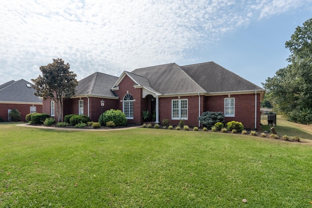 ranch-style house featuring a front lawn