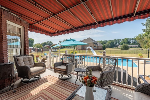 view of patio featuring a fenced in pool