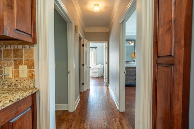 hallway with dark hardwood / wood-style flooring and crown molding