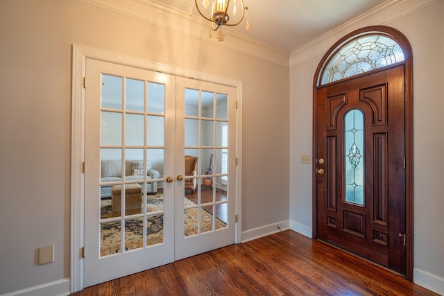 foyer entrance featuring crown molding, dark wood-type flooring, a wealth of natural light, and french doors