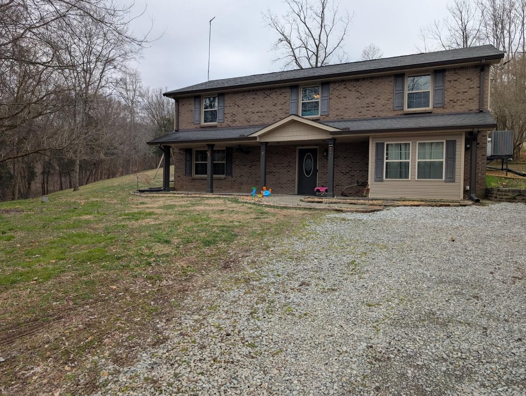 front of property with cooling unit and a front lawn