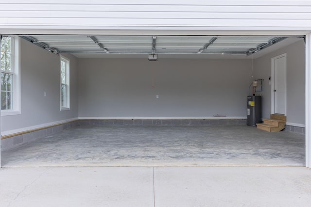 garage featuring a garage door opener and electric water heater