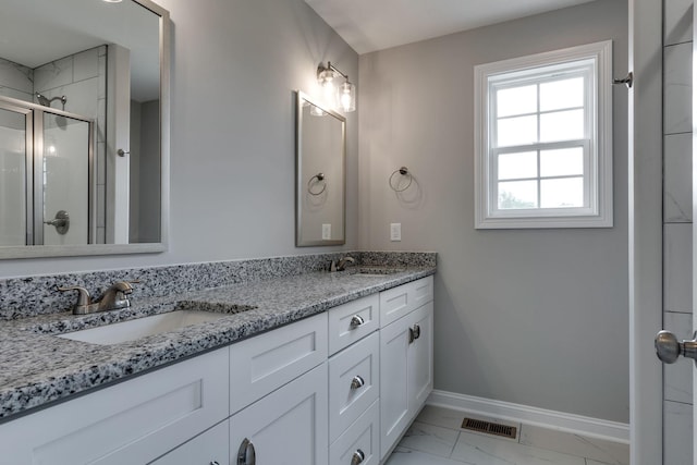 full bath with marble finish floor, visible vents, a sink, and baseboards