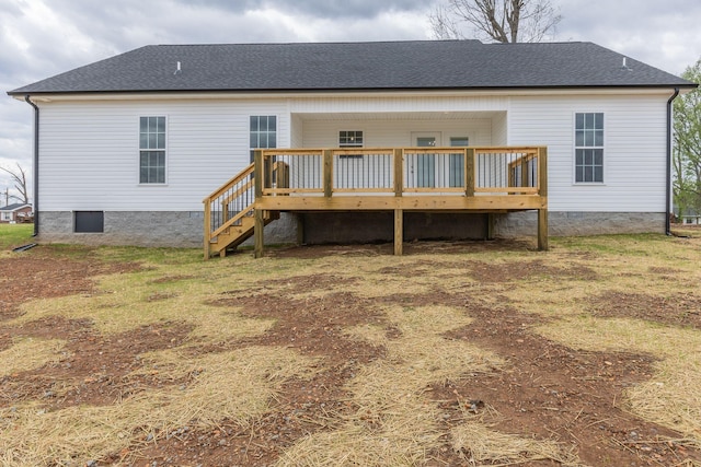 rear view of house with a wooden deck and a yard