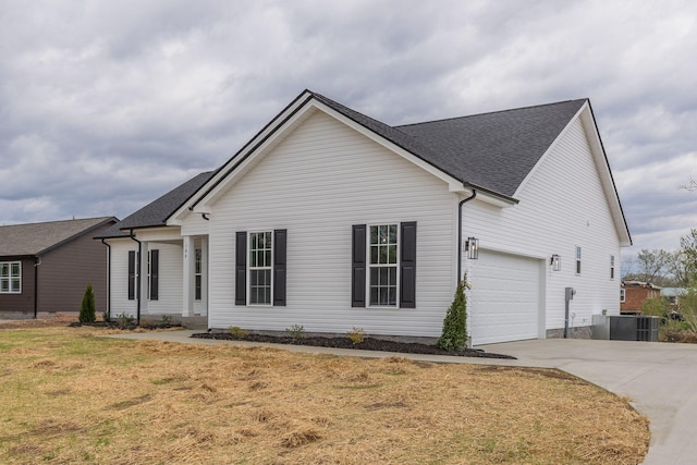 ranch-style home featuring central AC unit, a garage, and a front lawn