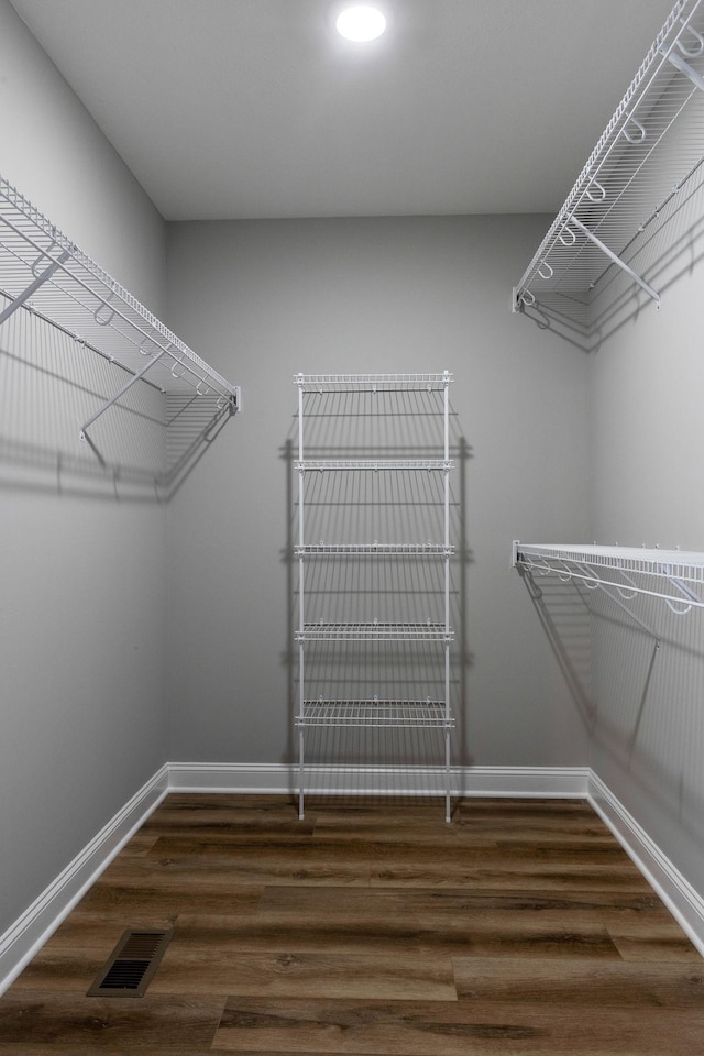 walk in closet with visible vents and wood finished floors