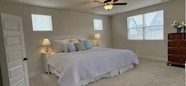 bedroom featuring light colored carpet and ceiling fan