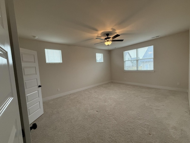 unfurnished room with ceiling fan and light colored carpet