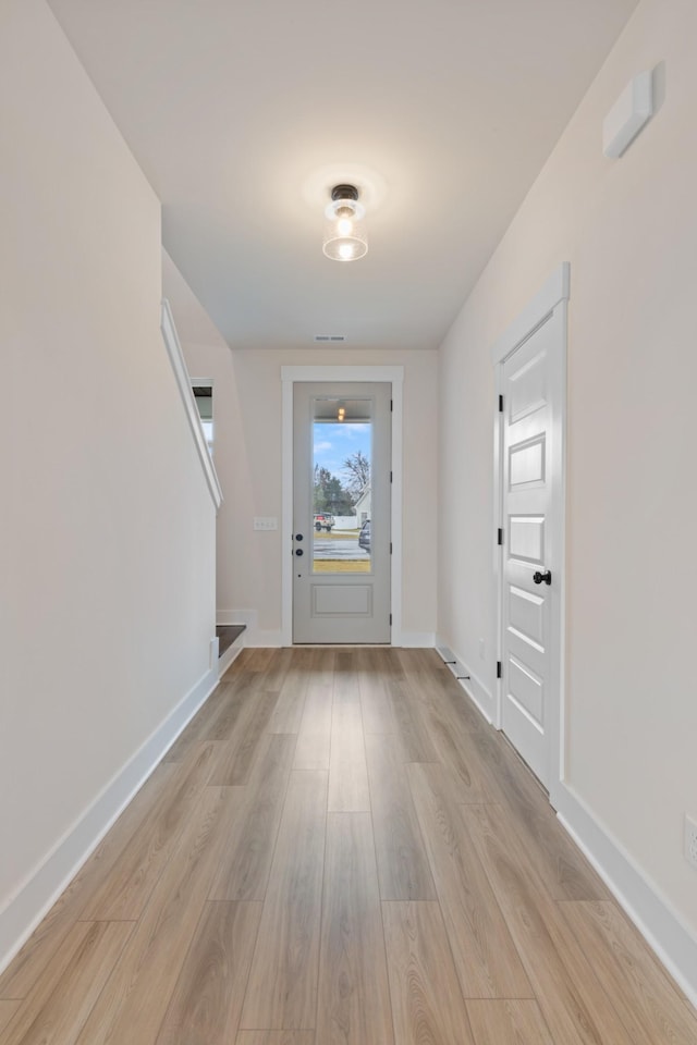 doorway to outside with light wood-type flooring