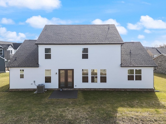 back of house with french doors, central AC unit, and a lawn