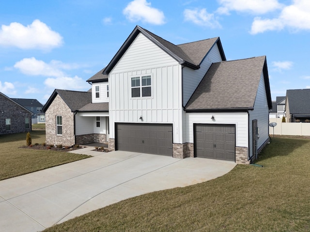 view of front of home with a front yard and a garage